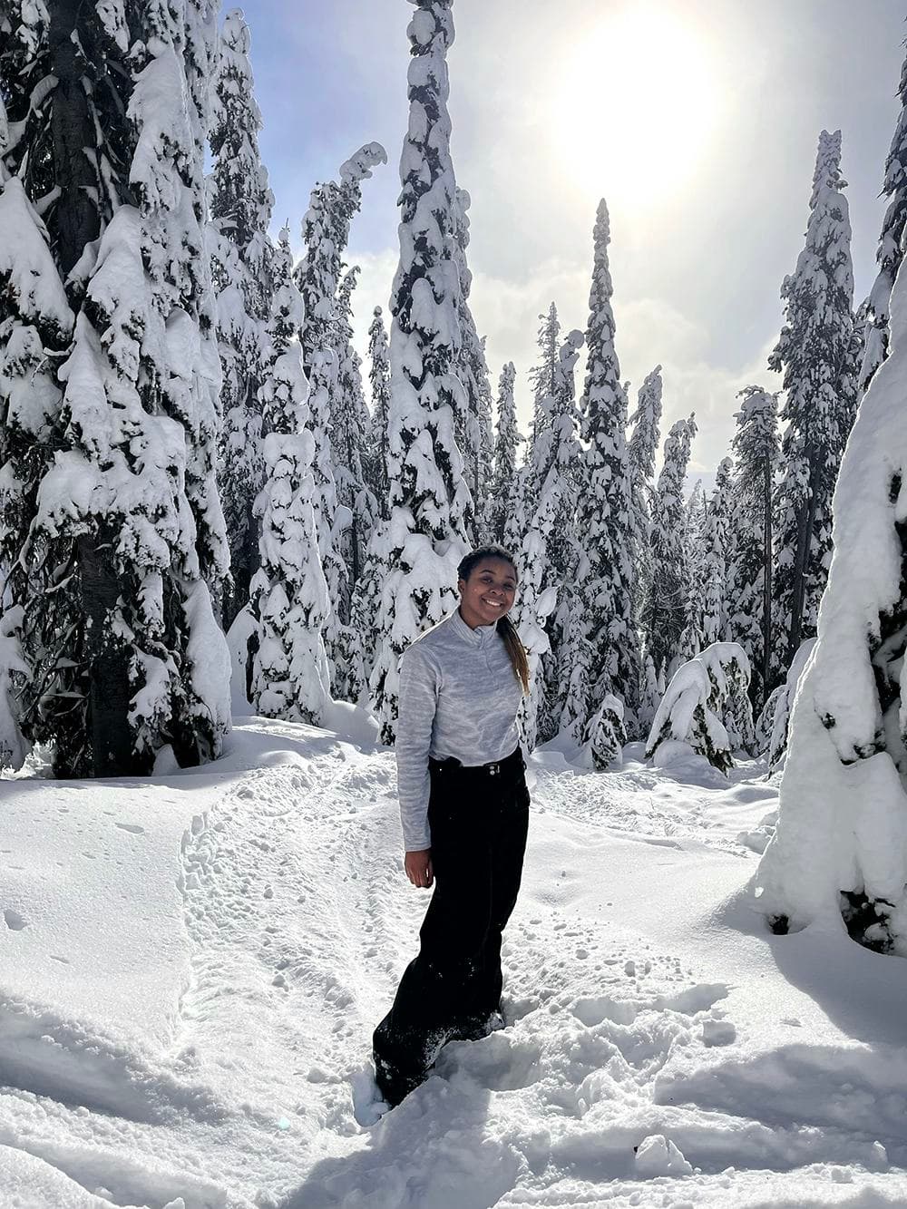 Student walking through a snowy forest during a school programme in Canada, experiencing daily life and the Canadian school system.