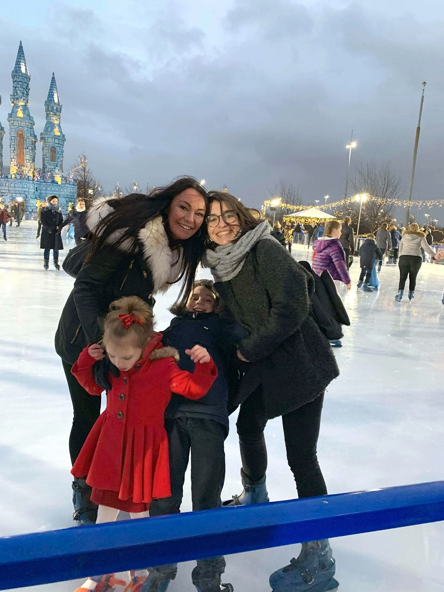 A smiling family enjoying recreational activities like ice skating, reflecting the everyday life experience during a school exchange year in the USA.