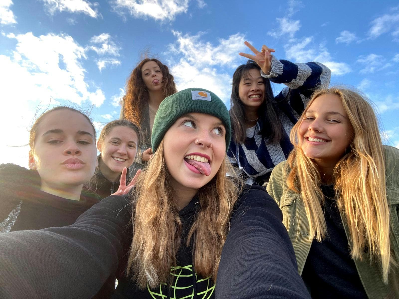 Students taking a selfie outdoors, showing friendships and everyday life during a school exchange programme in England.