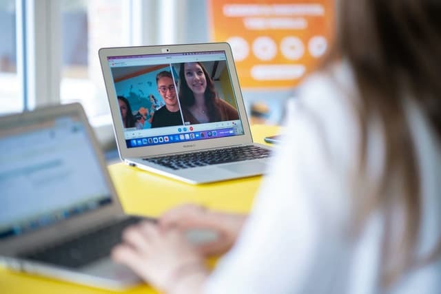 A student attends an online session about a Student exchange programme, receiving guidance and information through a video call.